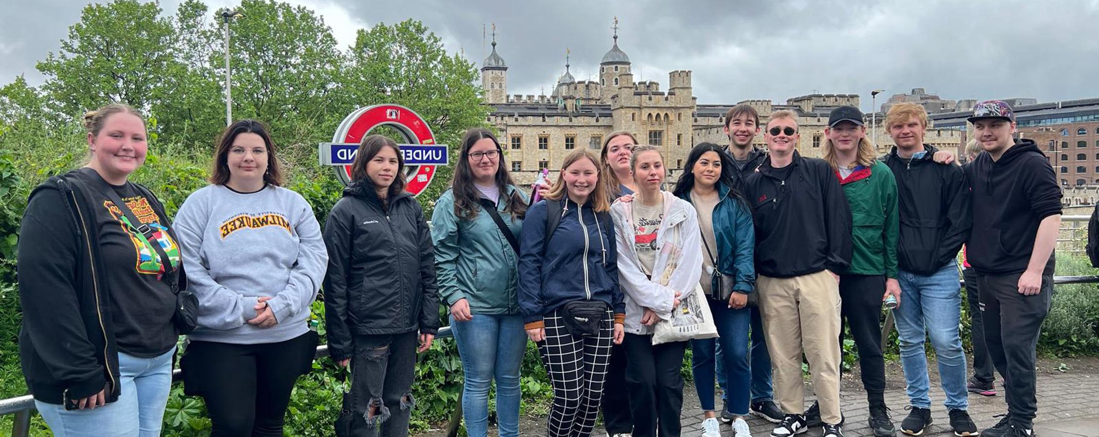 A group of students stand together outside while in Europe.