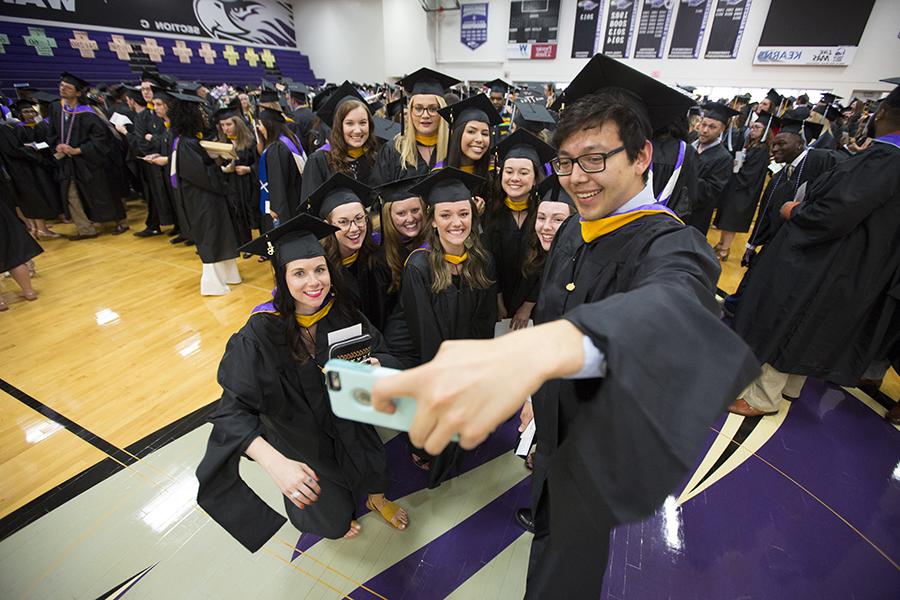 Students gather for a selfie at Commencement.