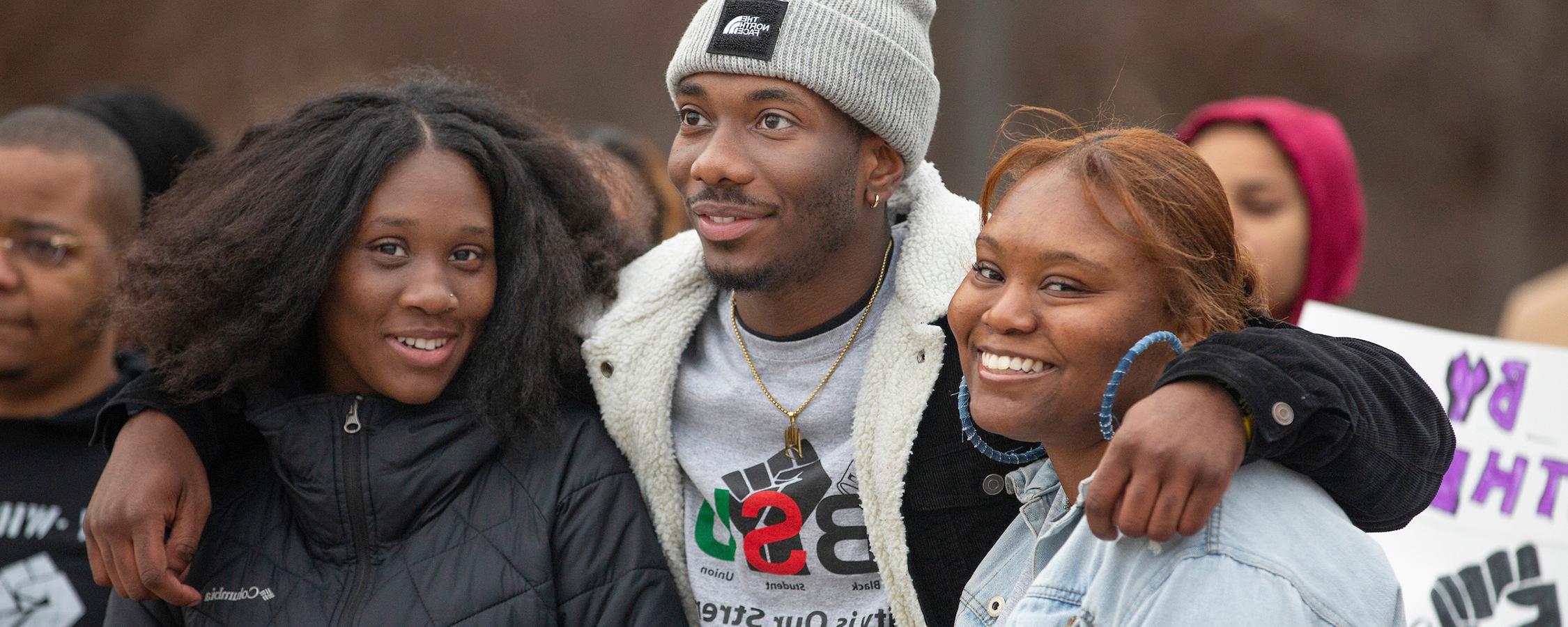 Group of black student union students smiling and hugging