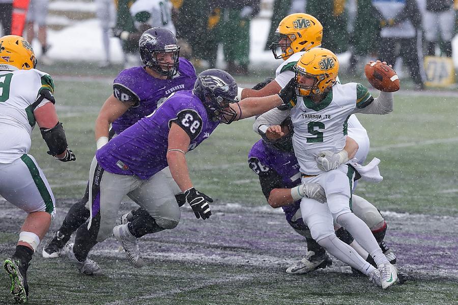 A Warhawk defensive lineman reaches for the opposing quarterback.