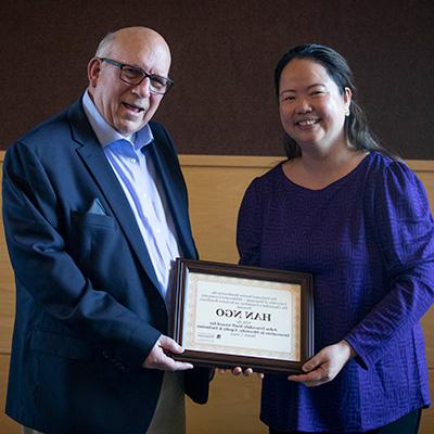 Truesdale Award being held by two people