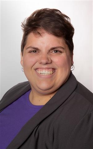 white woman in thirties with brown eyes and brown hair smiling