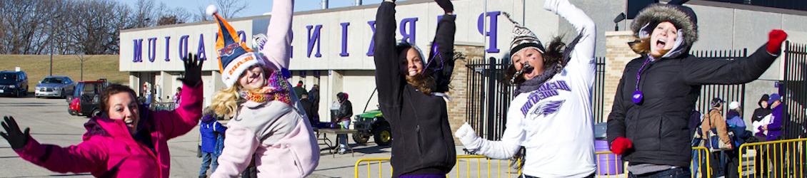 Students jumping in front of Perkins Stadium