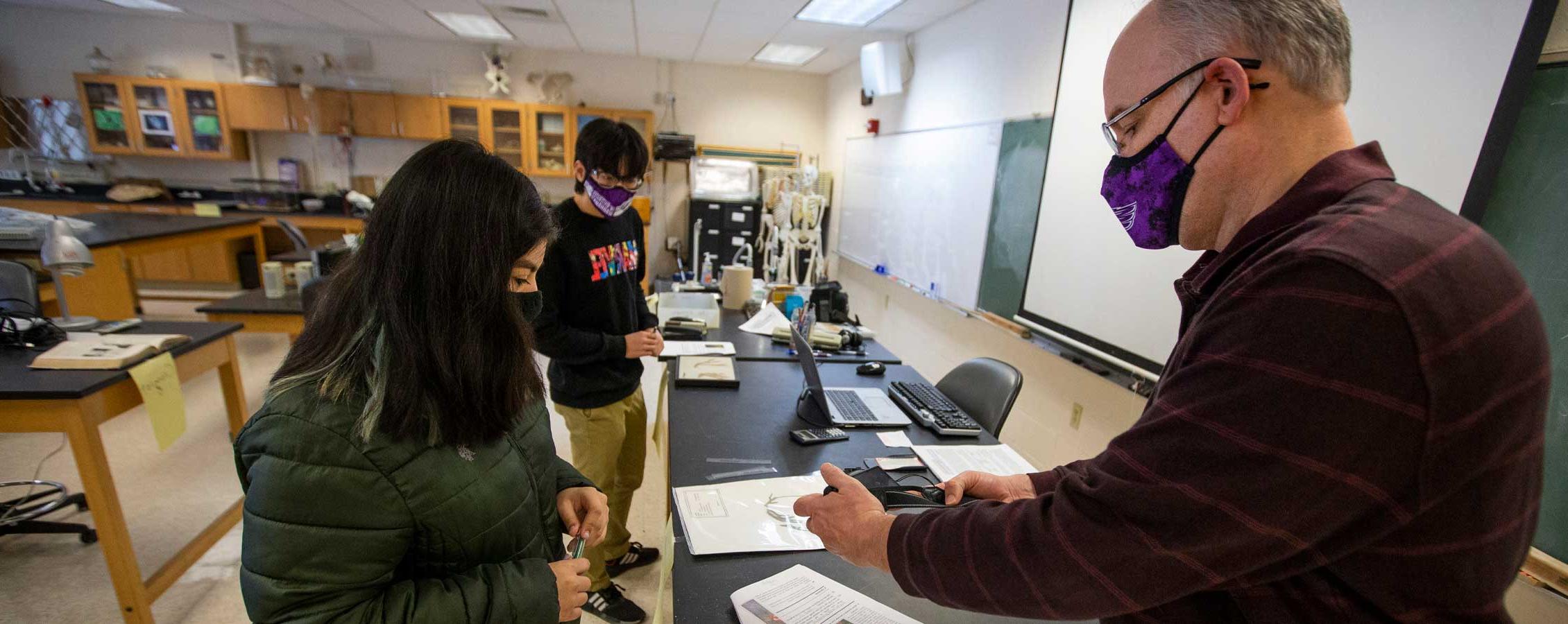 Tom Klubertanz stands in the lab with students.