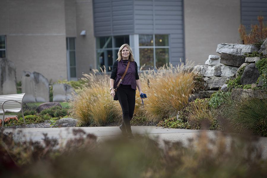 Barbara Kreisman walks outdoors.